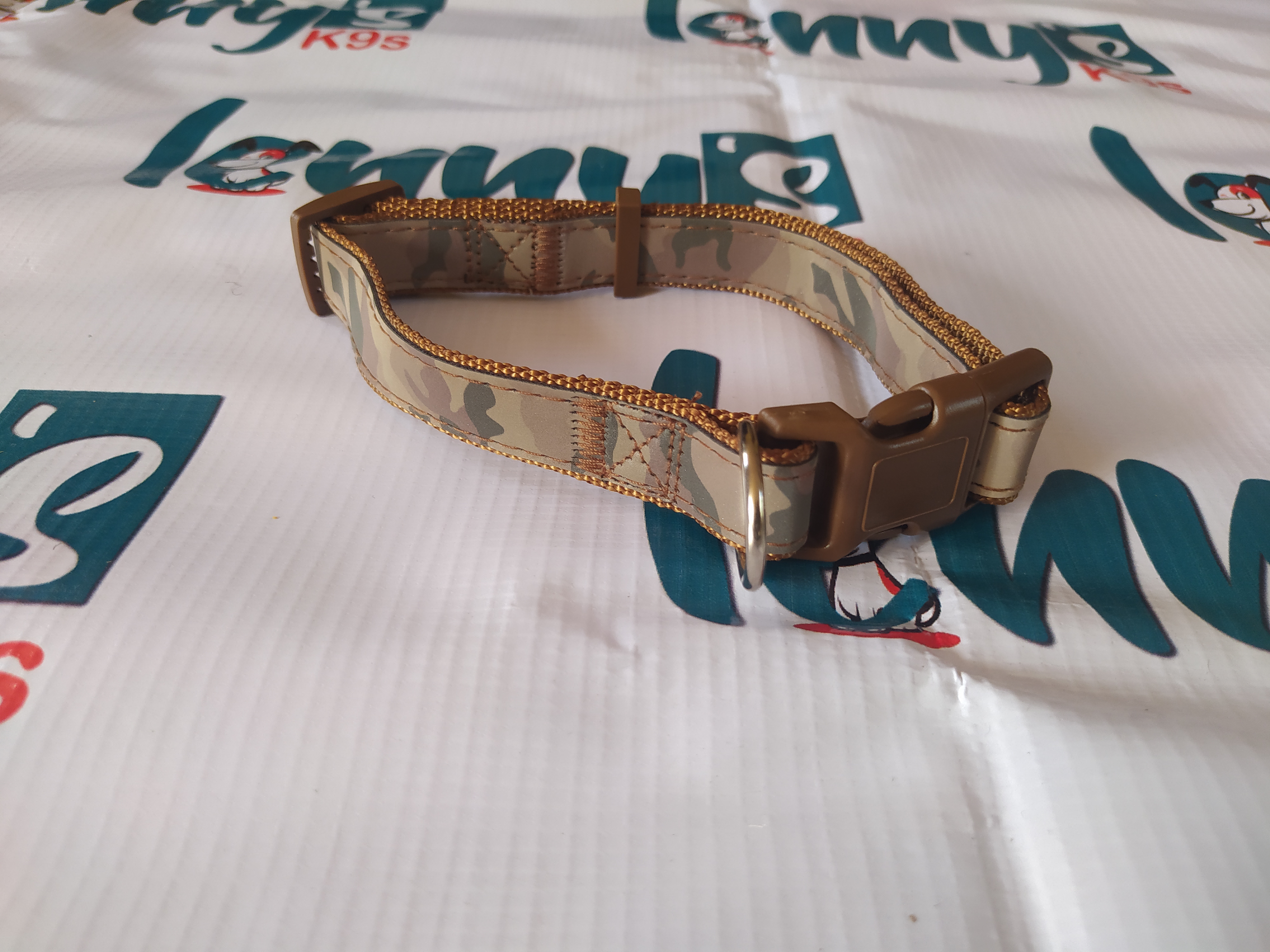Brown camouflage dog collar with buckle and D-ring.